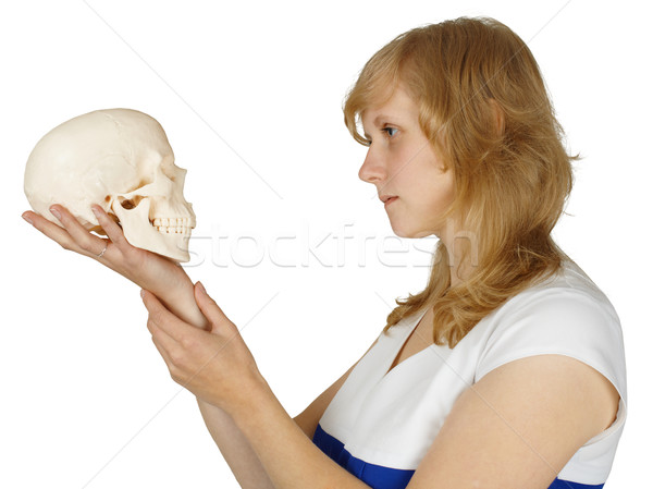 Woman examines a human skull on white Stock photo © pzaxe