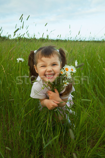 Cheerful child embraces wild flowers Stock photo © pzaxe