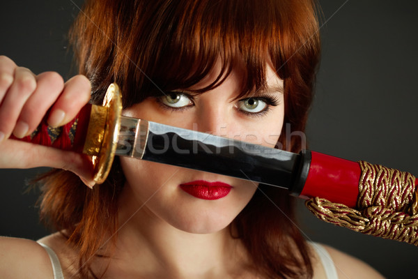 Young woman gets out of sheath a sword Stock photo © pzaxe