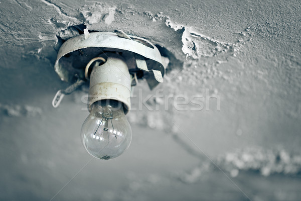 Old light bulb on ceiling of abandoned house Stock photo © pzaxe