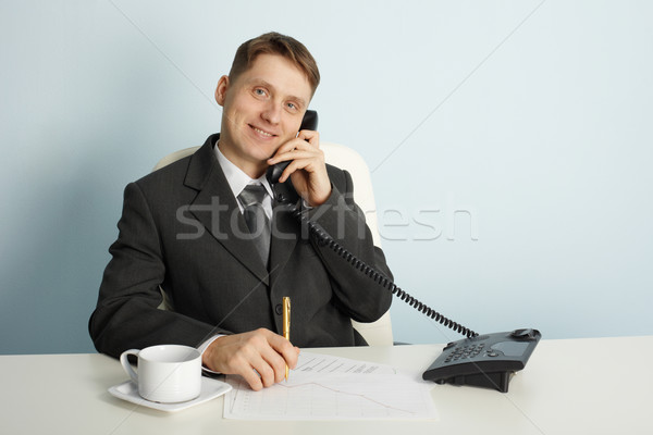 Smiling businessman in talks on phone Stock photo © pzaxe