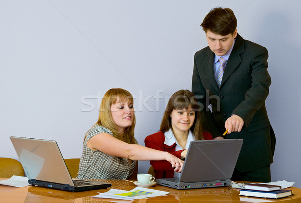 Girls at a desktop and their chief Stock photo © pzaxe