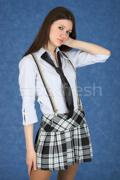 Girl in a skirt on a blue background Stock photo © pzaxe