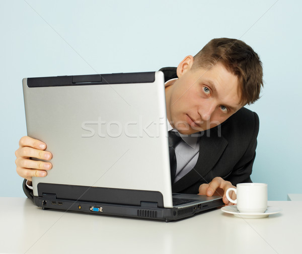 Young man looks negative sites on Internet Stock photo © pzaxe