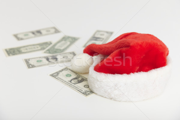 Christmas cap and dollars on white background Stock photo © pzaxe