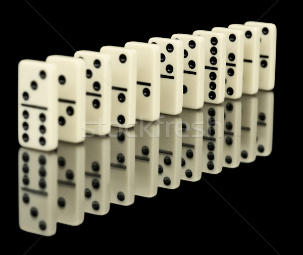Dominoes ranked on black background with reflection Stock photo © pzaxe