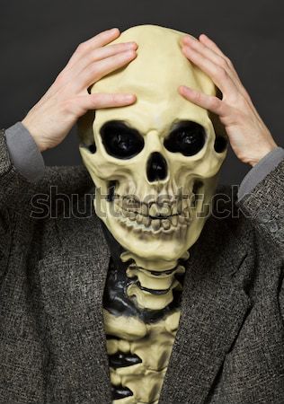 Skeleton has clasped hands a skull Stock photo © pzaxe