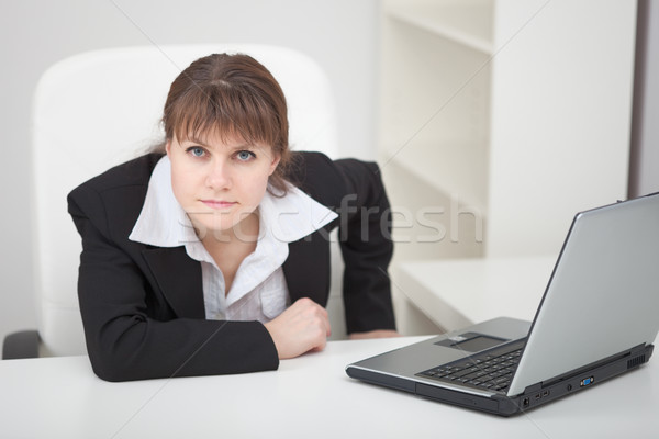 Resolutely woman - managing director sits at table with laptop Stock photo © pzaxe