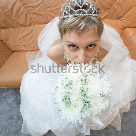 Bride comfortably lies on big leather sofa Stock photo © pzaxe