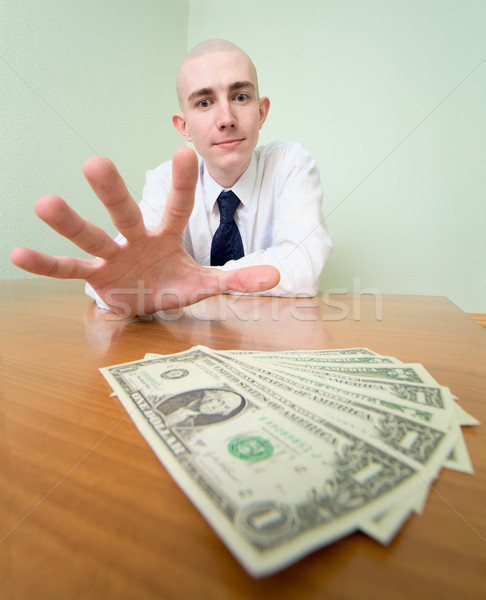 Man reaches for a batch of money Stock photo © pzaxe