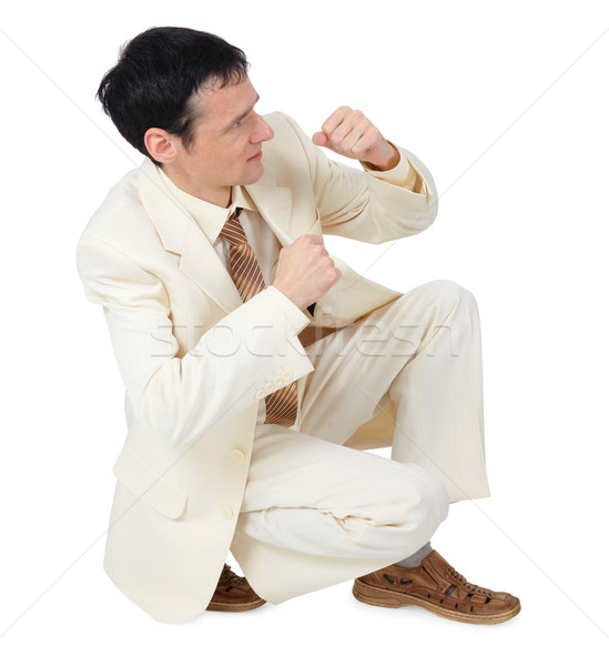 Businessman sitting in defensive posture Stock photo © pzaxe