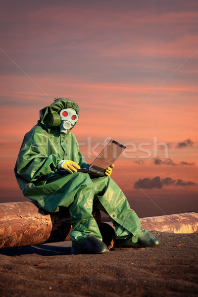Man in protective suit works in contamination area Stock photo © pzaxe