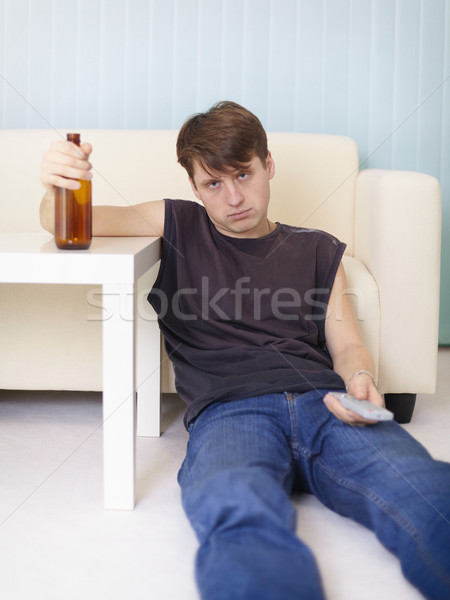 Pijany człowiek piętrze telewizja butelki niebieski Zdjęcia stock © pzaxe