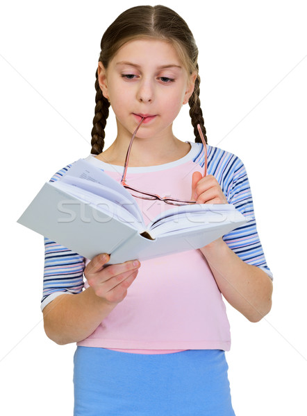 Schoolgirl reads the book on a white Stock photo © pzaxe