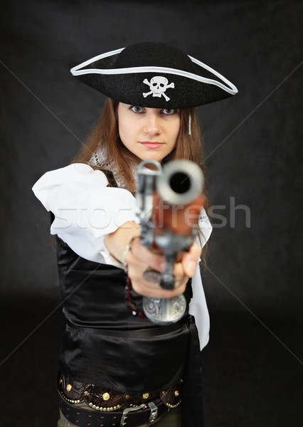 Woman pirate aims in us from an ancient pistol Stock photo © pzaxe