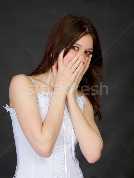 Stock photo: Scared beautiful girl on a black background