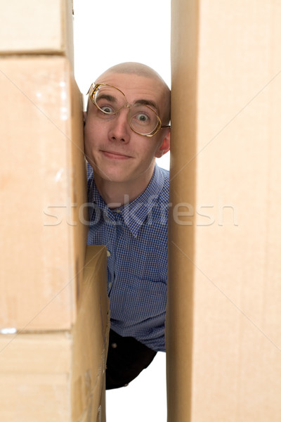 Male face clamping between cardboard boxes Stock photo © pzaxe