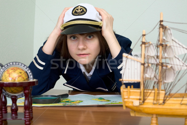 Scared girl in sea uniform at a table Stock photo © pzaxe