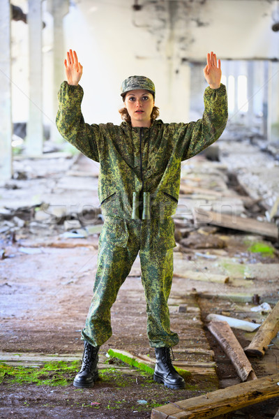 The woman in military uniform surrenders Stock photo © pzaxe