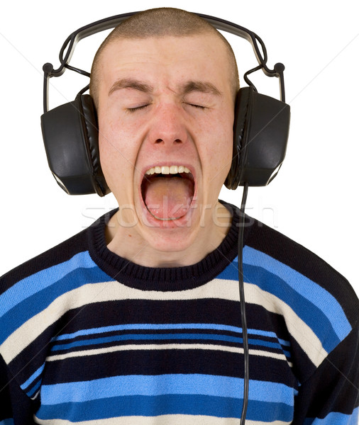 Young man in earphones loudly sings Stock photo © pzaxe