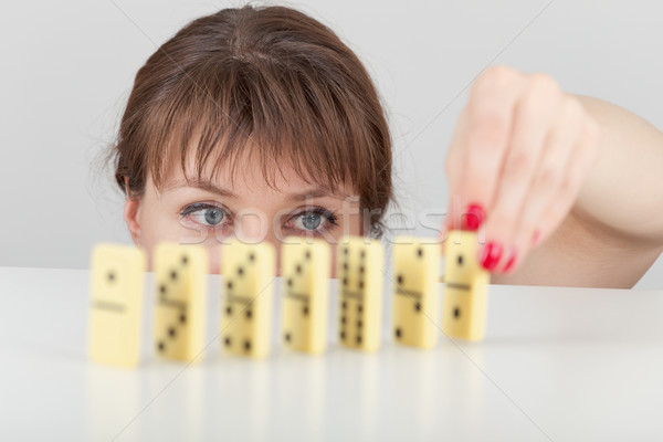 Girl builds line of dominoes counters close up Stock photo © pzaxe