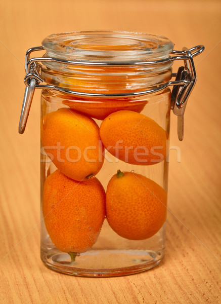 Kumquat in small tin can on wooden background Stock photo © pzaxe