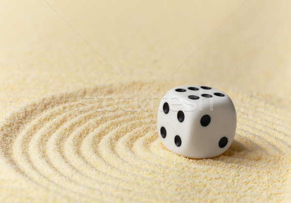 Playing white dice on yellow sand - art miniature Stock photo © pzaxe