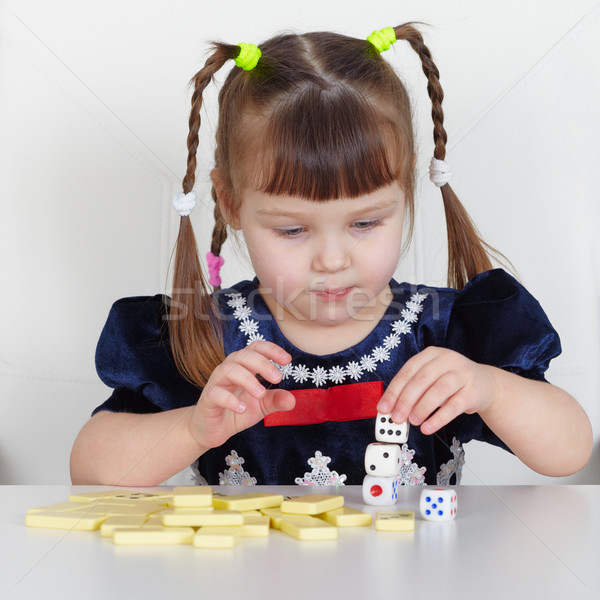 Child playing with small toys at table Stock photo © pzaxe
