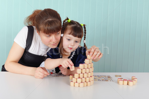 Stock photo: Mother and daughter playing with toys at table