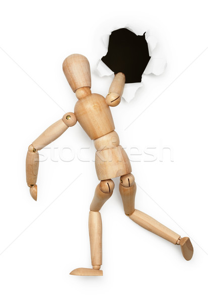 Wooden person tries to climb in hole on white Stock photo © pzaxe
