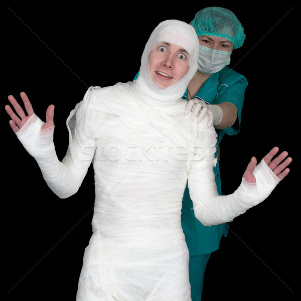 Funny sick in bandage and nurse on black background Stock photo © pzaxe