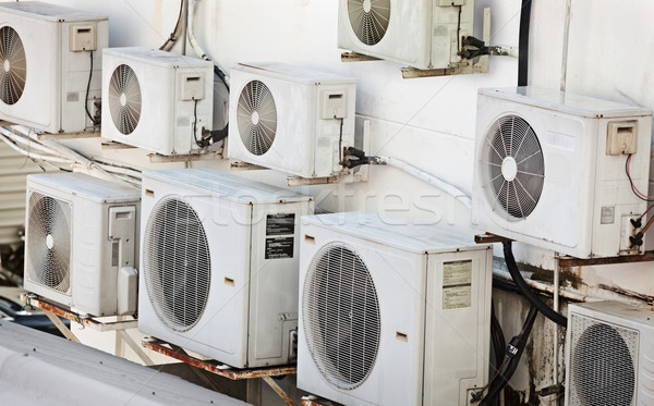Many older air conditioners on the wall Stock photo © pzaxe
