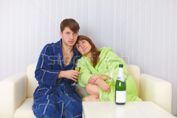 Husband and wife sit on sofa and drink fizz Stock photo © pzaxe
