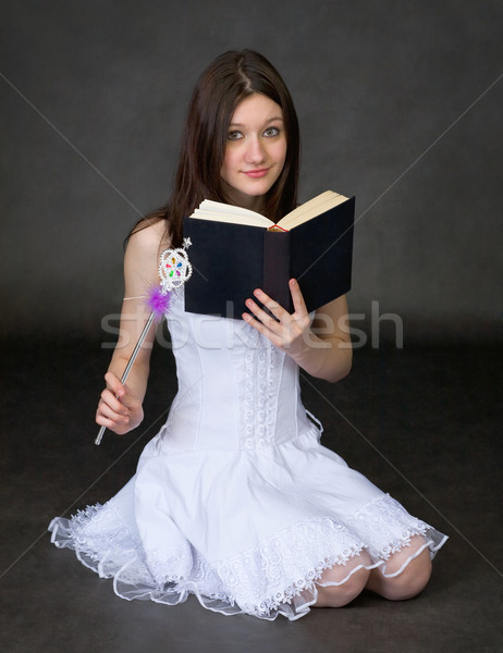 Girl with the book and a magic wand Stock photo © pzaxe