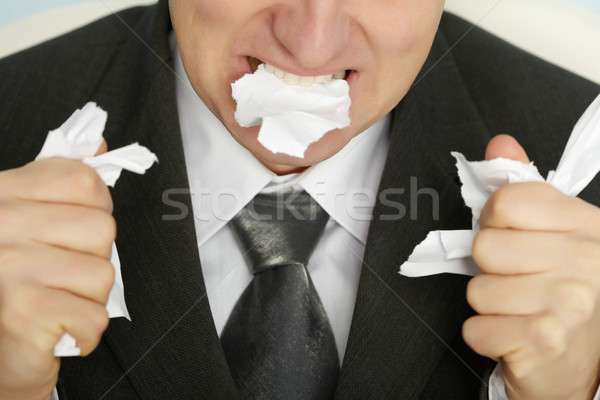 Businessman furiously tearing paper Stock photo © pzaxe