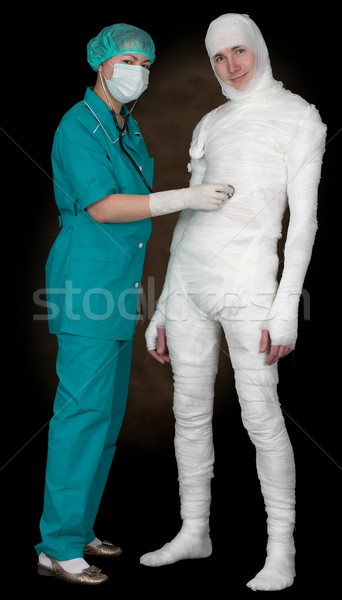 Man in bandage and nurse with stethoscope Stock photo © pzaxe
