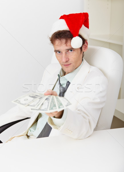 Man in Christmas hat gives us money Stock photo © pzaxe