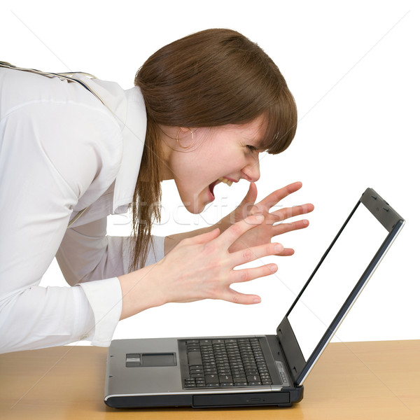 Girl emotionally shouts at the laptop Stock photo © pzaxe