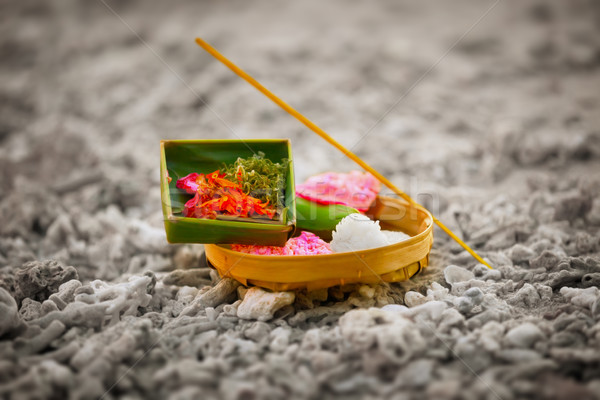 Offerings to gods in Bali with flowers, rice and aroma stick Stock photo © pzaxe