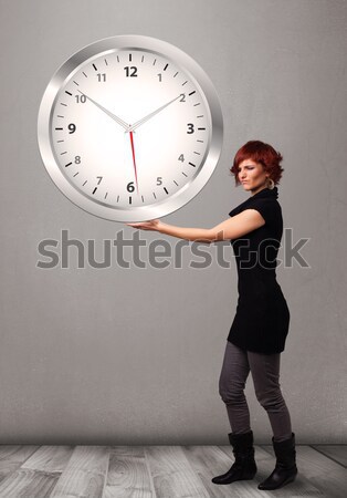 Attractive lady holding a huge clock Stock photo © ra2studio