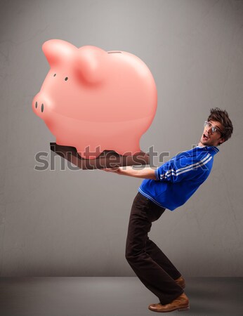 Homem bonito enorme poupança piggy bank bonito Foto stock © ra2studio