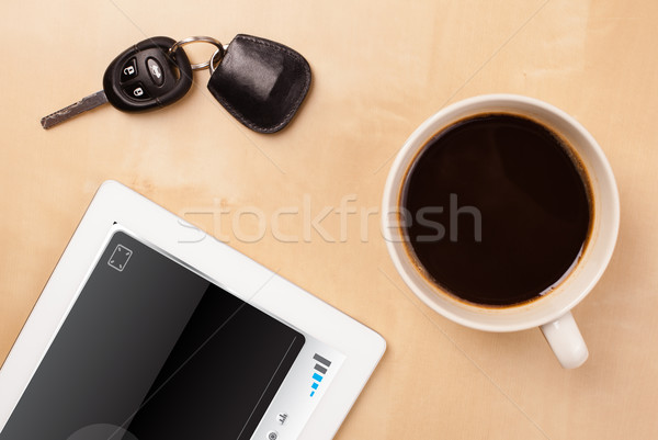 Workplace with tablet pc showing media player and a cup of coffee on a wooden work table closeup Stock photo © ra2studio