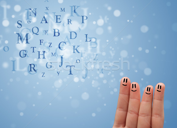 Stock photo: Happy smiley fingers looking at mixture of bokeh letters