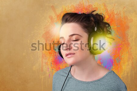 Young woman with headphones listening to music Stock photo © ra2studio