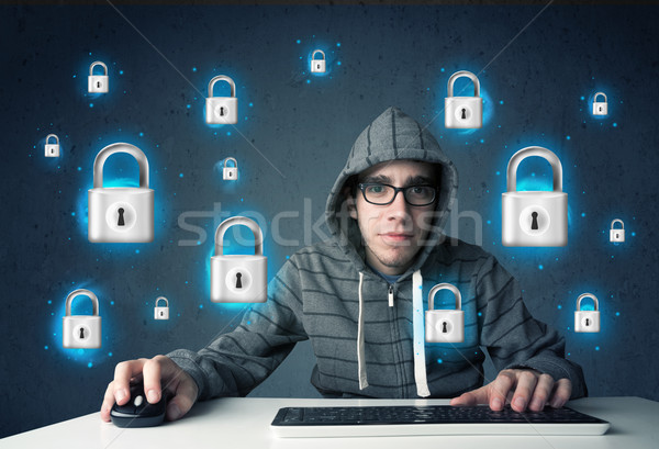 Young hacker with virtual lock symbols and icons Stock photo © ra2studio