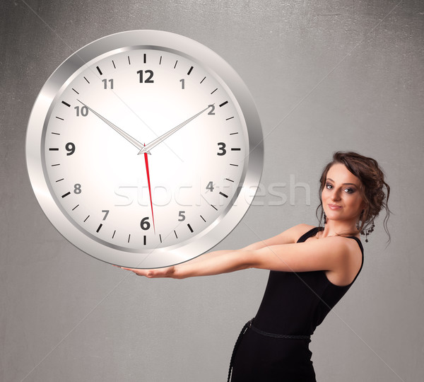 Attractive lady holding a huge clock Stock photo © ra2studio