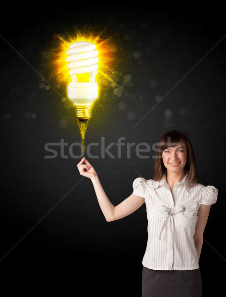 Businesswoman with an eco-friendly  bulb Stock photo © ra2studio