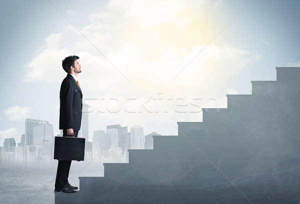 Businessman climbing up a concrete staircase concept Stock photo © ra2studio