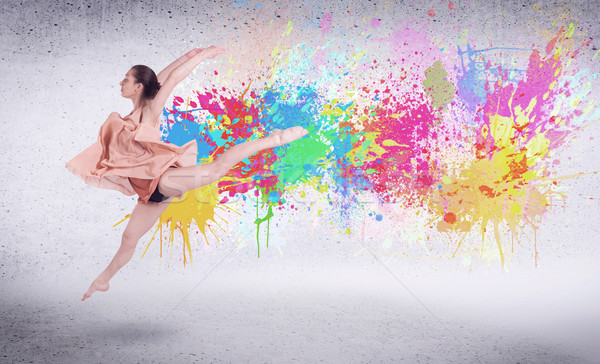 Modern street dancer jumping with colorful paint splashes Stock photo © ra2studio