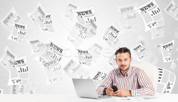 Business man at desk with stock market newspapers Stock photo © ra2studio